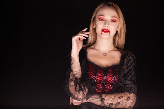 Caucasian woman wearing a seductive vampire costume for halloween. Attractive woman.