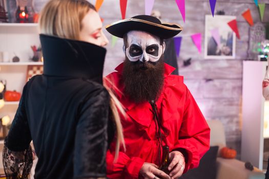 Man dressed up like a pirate with creative makeup celebrating halloween with his friends