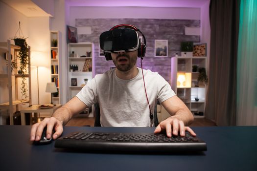 Pov of concentrated professional online gamer wearing virtual reality headset.