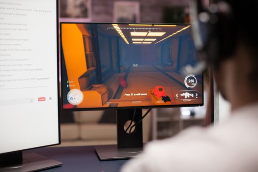 Computer display with online shooter game. Professional gamer streaming.