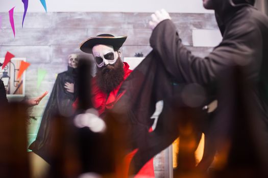 Man wearing creepy medieval pirate outfit while celebrating halloween with his friends.