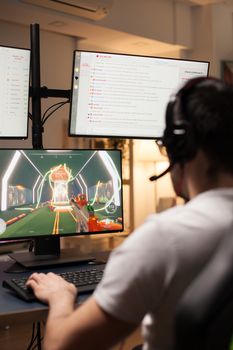 Young man in a stream of online shooter game wearing headphones.