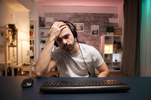 Pov of young man can't believe it's game over for him while playing online shooter games.