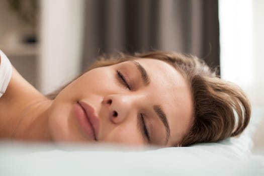 Close up portrait of beautiful young woman sleeping in the morning.