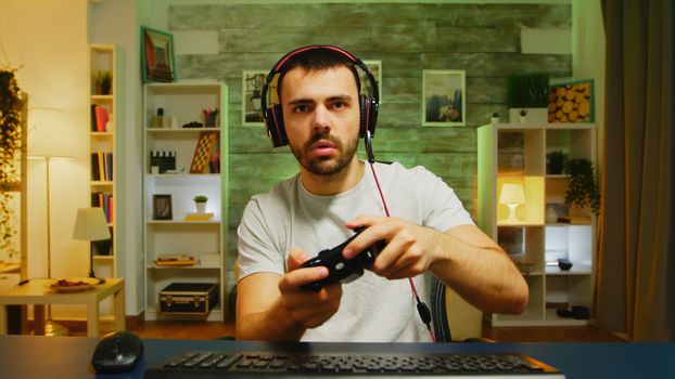 Pov of excited young man after winning the championship on online game. Wireless controller.