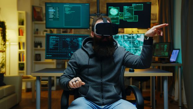 Bearded hacker wearing a virtual reality goggles. Internet criminal.