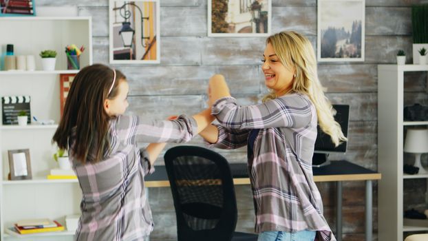 Happy mother and daughter dancing together. Happy children.