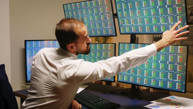 Businessman checking his stock market investments while the company loses money.