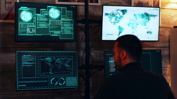 Zoom in shot organized cyber criminals in dark room with super computers hacking the government.