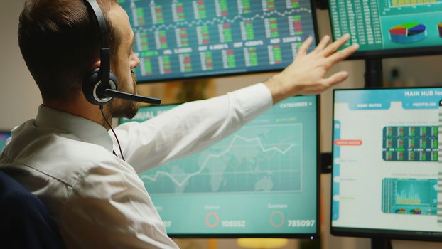 Broker with headphones checking the stock market while the economy is a disaster.