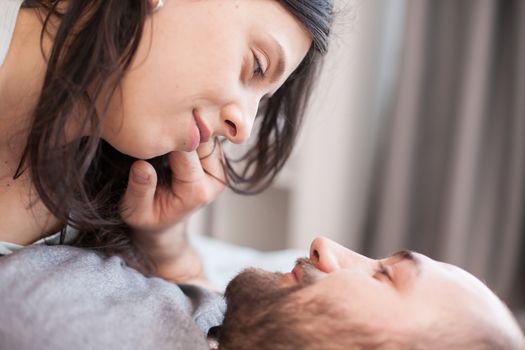 Close up of romantic couple looking at each other eyes after waking up.