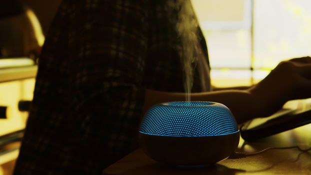 Silhouette of vapor with essential oils from diffuser in an apartment.