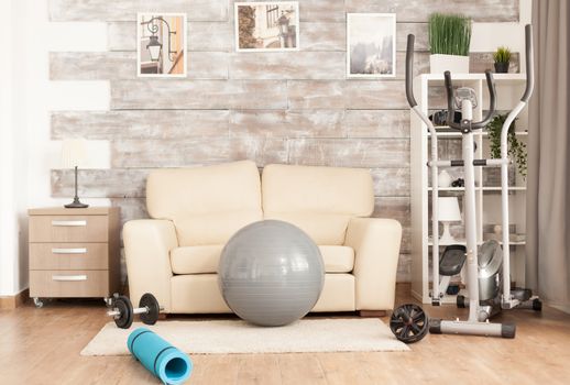 Modern fitness accessories on empty room for workout.