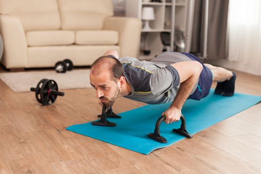 Fit man increase his chest strength doing push ups during global pandemic.