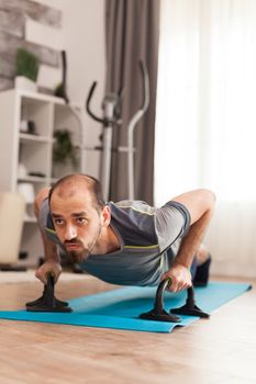 Man training his chest muscles doing push ups in time of coronavirus outbreak.