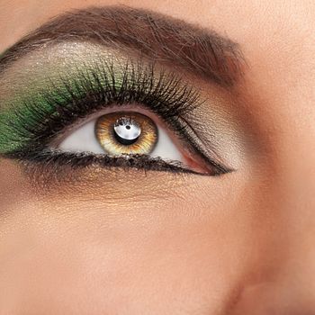 Close up eye with green make up. Close up shooting. Beauty and fashion. Glamour and on stage make up. Make-up art