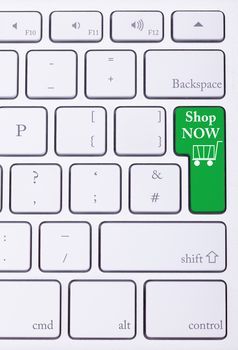 Shop now green key on aluminium keyboard. Sale and online shoping. Consumerism