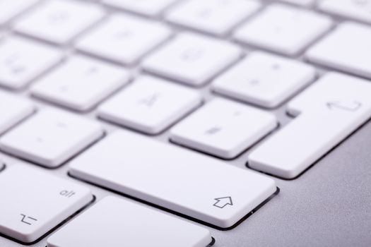 White aluminum keyboard in close up. Technology and communication