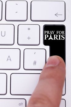 Pressing black button with pray for paris text and sign. Terrorist attack against France