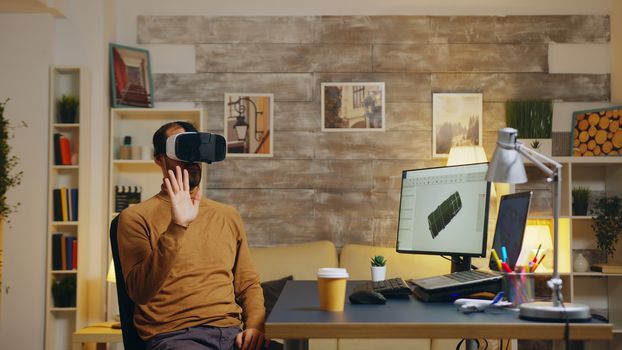 Mechanical engineer using virtual reality headset to design a turbine system.