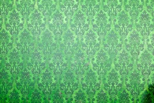 Green vintage pattern on old wall. Rich vintage retro pattern interior