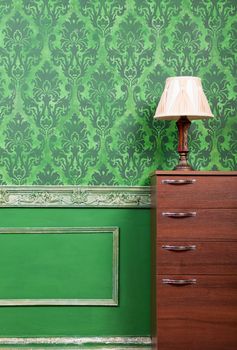 Lamp on furniture in green vintage interior. Rich rococo period home. Interior photoshooting