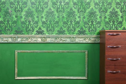 Interior of room painted in green with vintage elements. Retro baroc pattern. Rich vintage interior