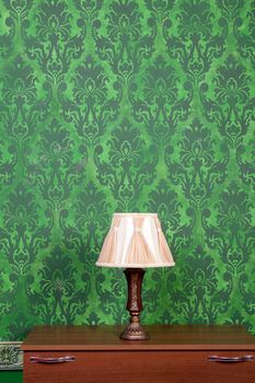 Vintage lamp on chimney on green retro pattern background. Rococo style