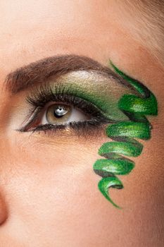 Eye with professional artistic green make up in studio photo