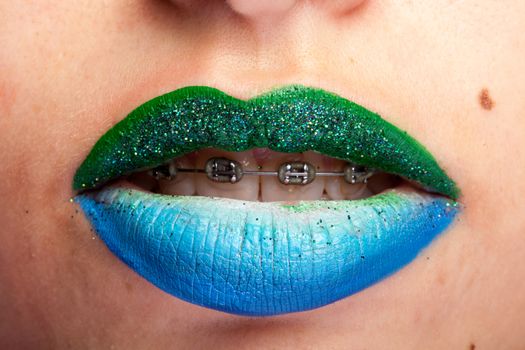 Beauty image of lips with artistic make up in studio photo