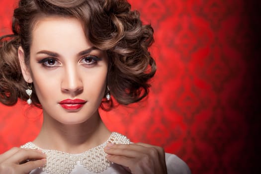 Fashion woman in red vintage room. Professional make up and hairstyle. Vintage and retro style