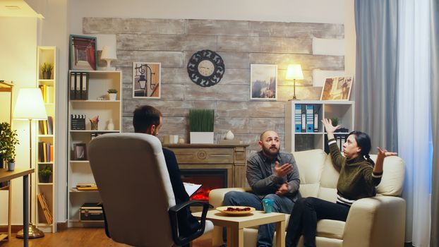 Young couple on a counseling session with psychotherapist. Relationship guidance.