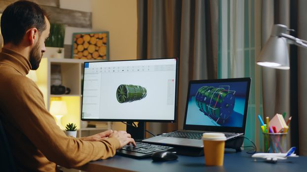 Handsome engineer in his home office developing a new turbine. Creative freelancer.
