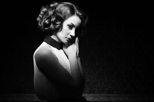 Beautiful woman black and white vintage image. Professional make up and hairstyle. Retro style. Studio lighting