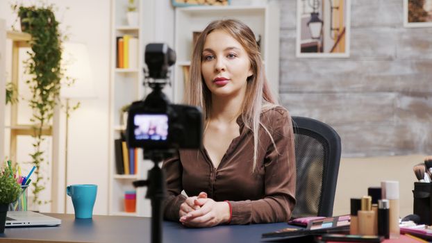 Female makeup artist recording a vlog how to use the right cosmetics. Famous influencer.