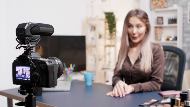 Beautiful beauty influencer recording a video about fashion makeup. Creative content creator.