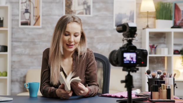 Beautiful makeup artist recording vlog for followers. Using professional equipments for recording