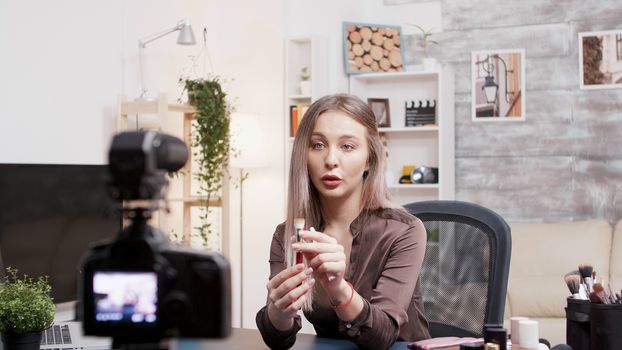 Famous beauty influencer showing how to use makeup brush. Social media star