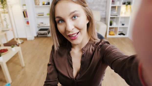 POV video of beauty influencer smiling while recording a new fashion vlog. Creative content creator.