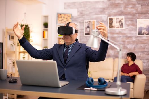 Elderly man experiencing new virtual reality technology for the first time in his home