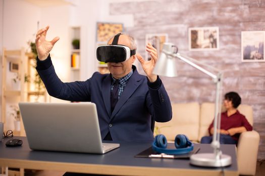 Elderly man experiencing new virtual reality technology for the first time in his home