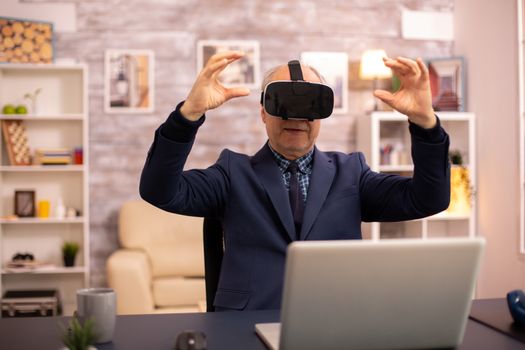 Elderly man experiencing new virtual reality technology for the first time in his home