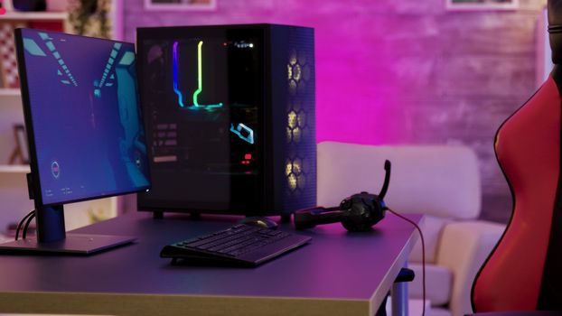 Pc unit un colorful neon lighst for online gaming. Gaming chair
