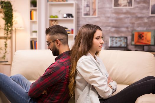 Caucasian couple sitting back to back with serious relationship problems. Unhappy couple.