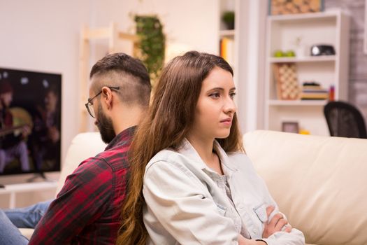 Caucasian couple sitting back to back with serious relationship problems. Unhappy couple.