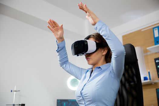 Blonde caucasian woman exploring virtual reality in neurology clinic.