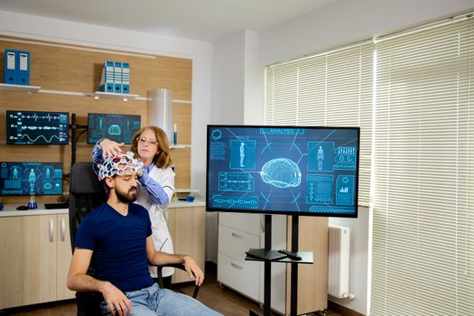 Patient who undergoes a brain scan procedure in a neurological center. Modern lab