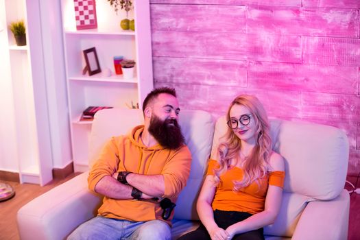 Boyfriend looking at his girlfriend after winning aginst her at online video games.
