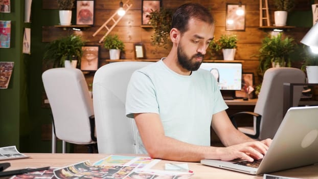 Young designer working in a cozy office on a laptop. Smart and modern office