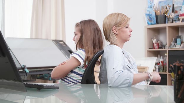 Mother and daughter angry at each other. Young female and her teenage girl having a conflict.